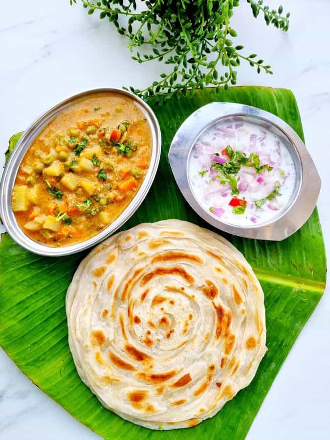 South Indian breads like chapati, parotta, and poori served hot on a plate