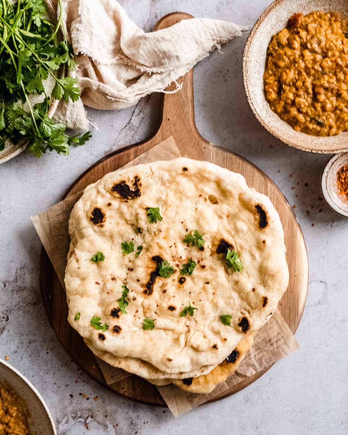 North Indian breads like naan, roti, butter naan, and kulcha served on a plate